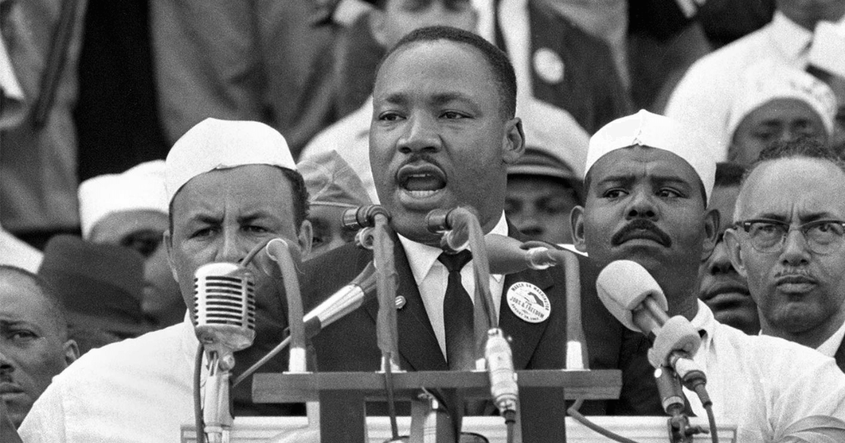 Black and white photo of MLK giving a speech.