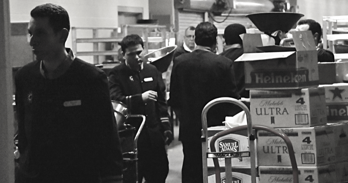 Black and white image of workers in the back of a store.