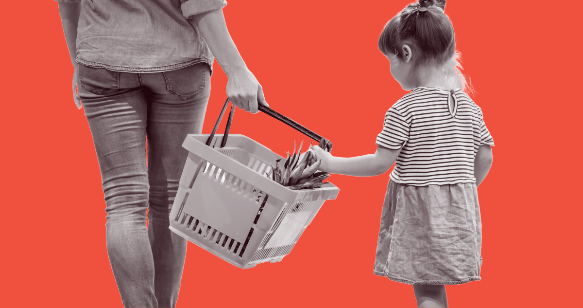 Daughter placing food into her mother's shopping basket.