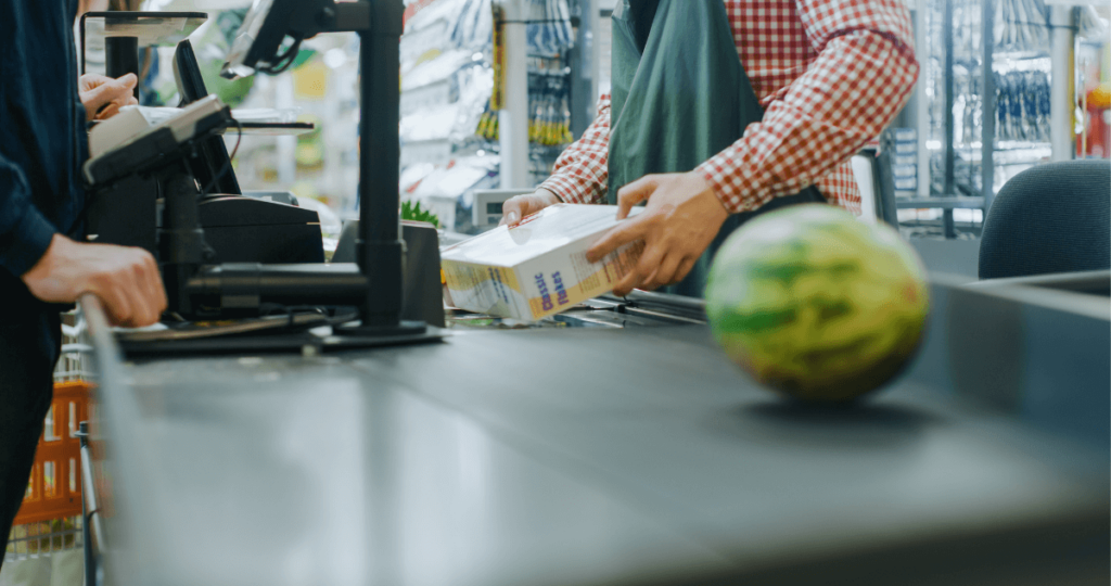 A man checking out groceries at a store.