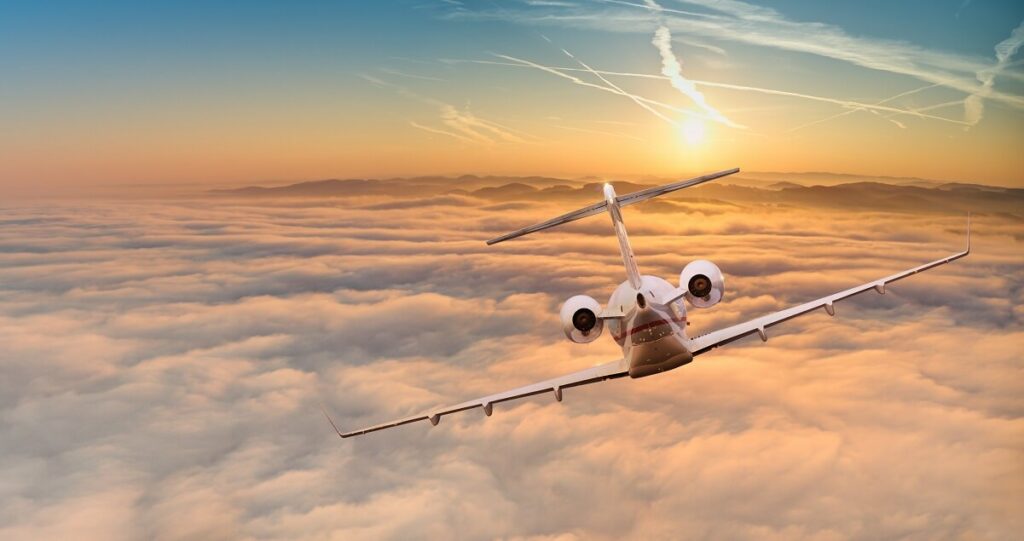 Private jet flying in the clouds.