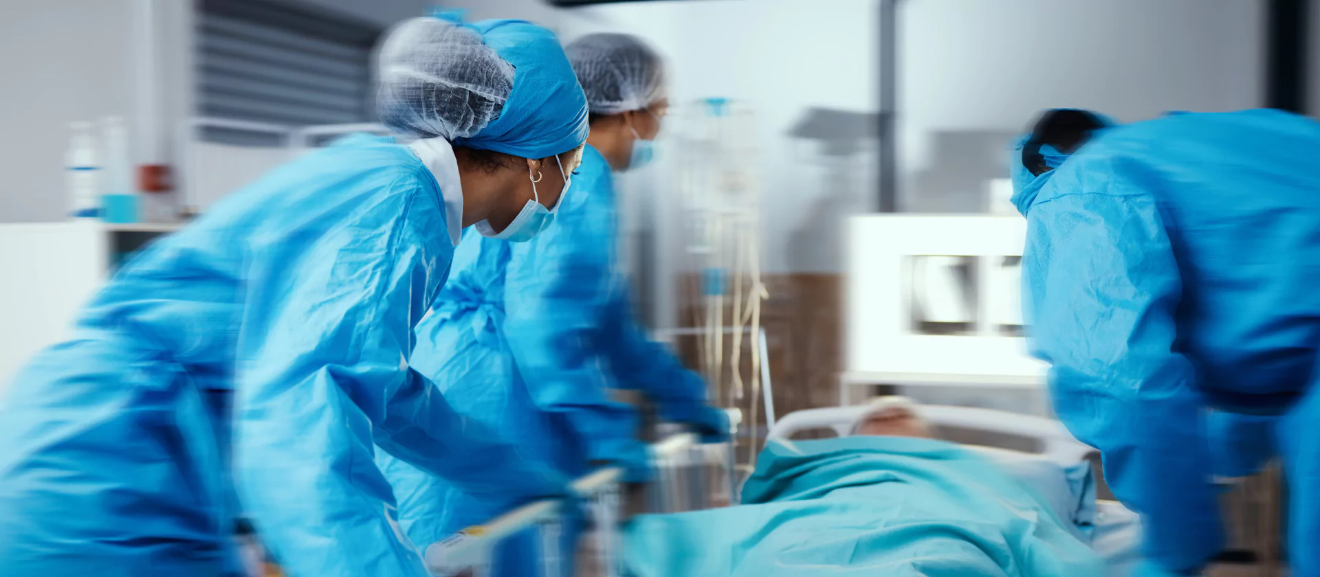 nurses and doctors rushing patient into operating room
